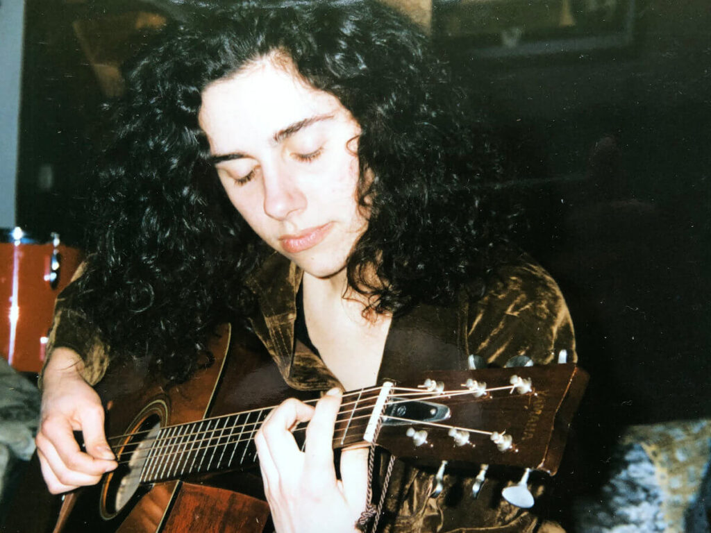 PJ Harvey with her first guitar. Taken by Eva Harvey in 1986.